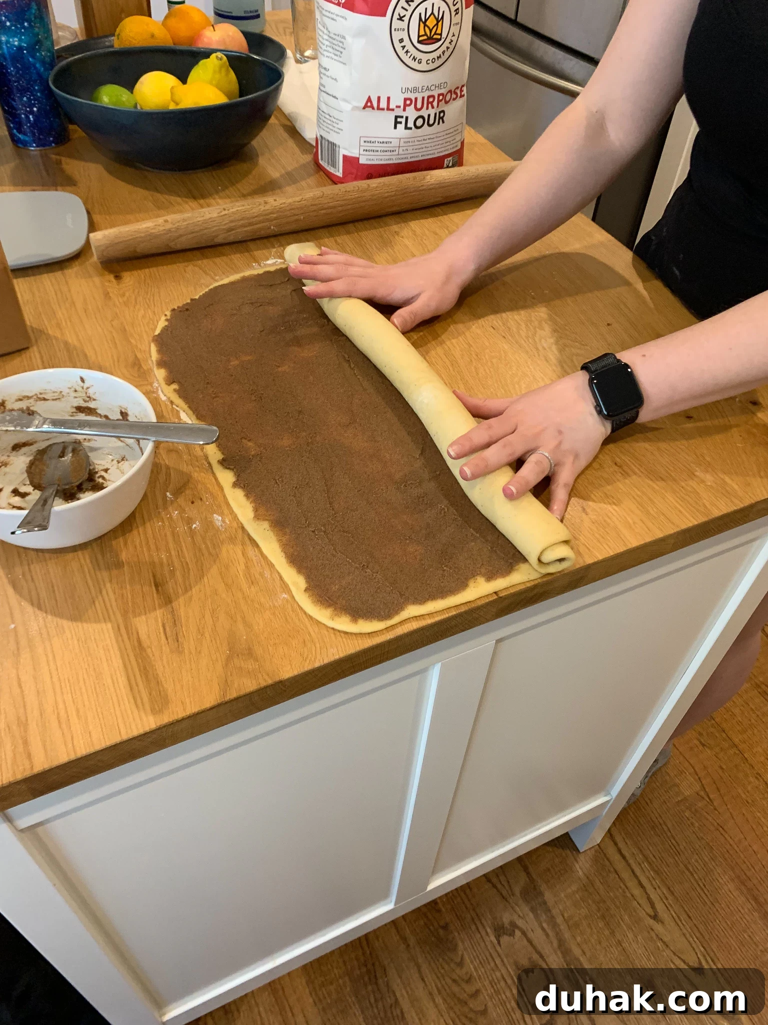Rolling the dough up into a log.