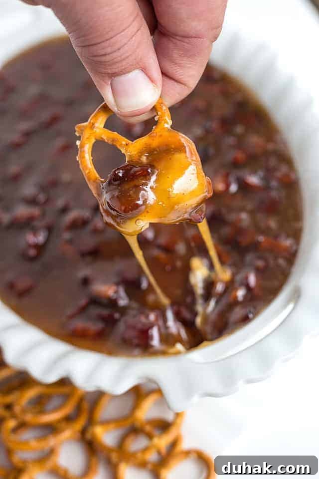 Pretzel dipped in maple bacon sugar cookie dip pretzel dipped in maple bacon sugar cookie dip