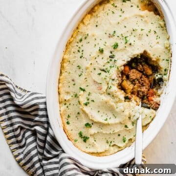 keto shepherd's pie in a white pan with a spoon inside