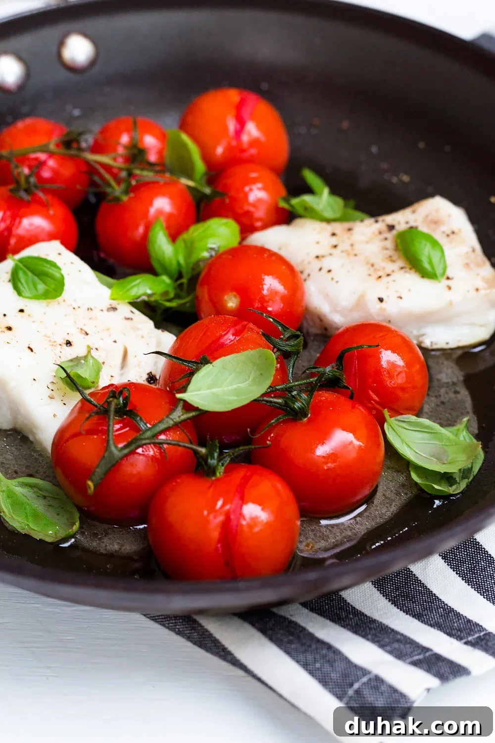 Tomato Basil Baked Cod with Lemon and Garlic 4 Cod with Tomatoes and Basil up close.
