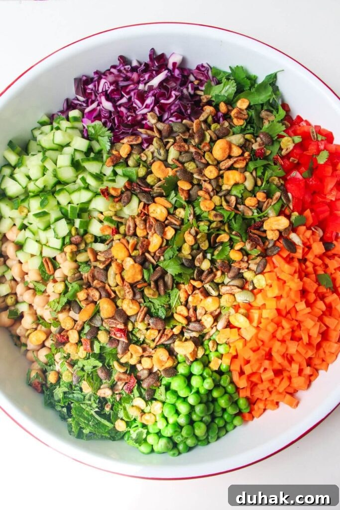 Rainbow chopped salad ingredients in a large white bowl.