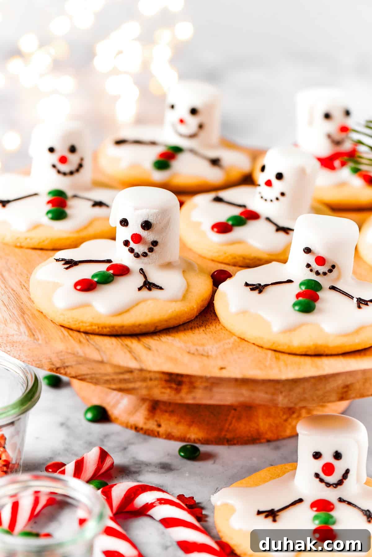 Melting snowman cookies are arranged on a cake plate.