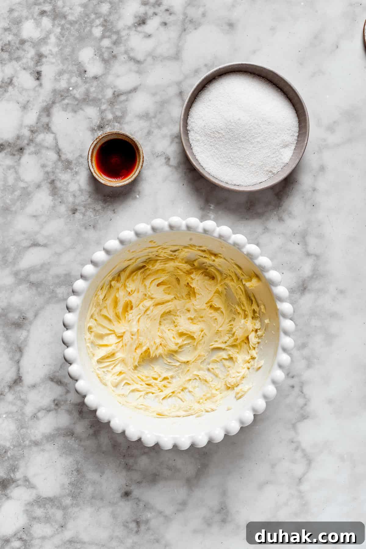 Butter and sugar creamed in a bowl.