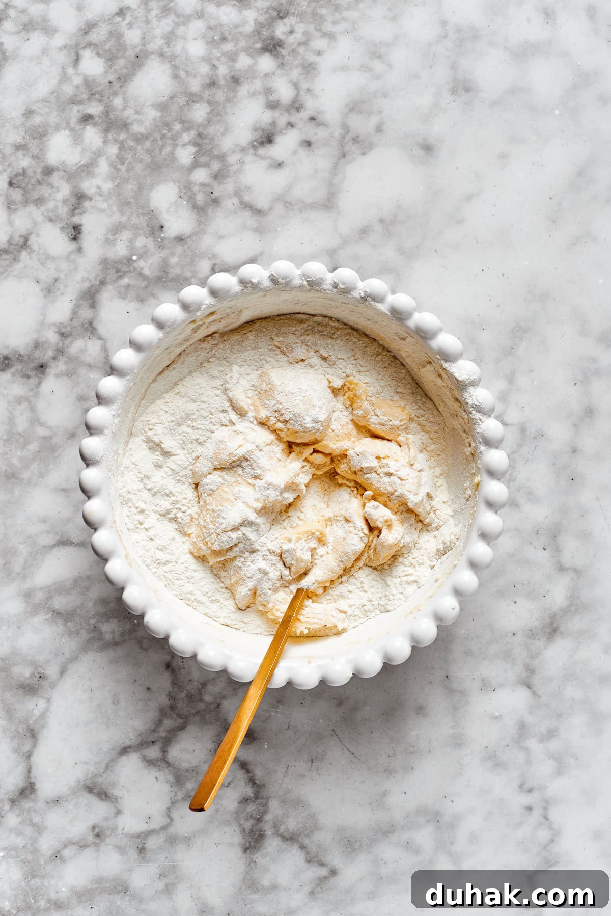 Flour is mixed into cookie dough.