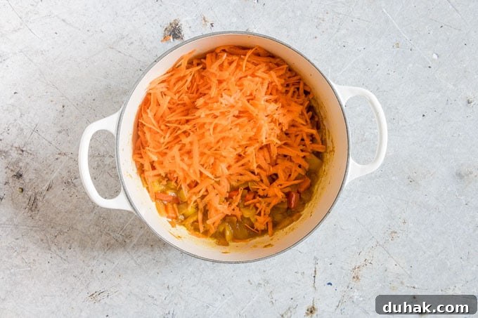 Chakalaka: Traditional South African Spicy Vegetable Relish (Vegan, Gluten-Free) 4 overhead shot of chakalaka recipe being prepared with shredded carrots on top