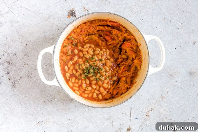 Chakalaka: Traditional South African Spicy Vegetable Relish (Vegan, Gluten-Free) 7 overhead shot of white pot with chakalaka with baked beans and fresh thyme on top