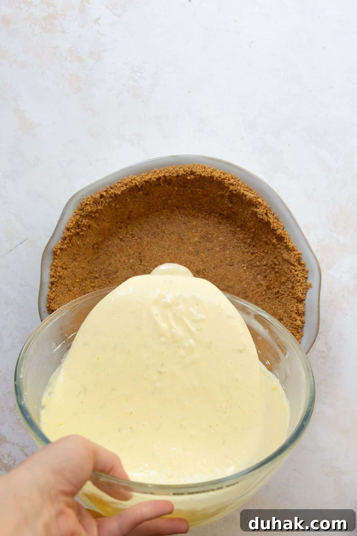 Key Lime Pie (Gluten-Free) — Zesty Citrus Dessert Recipe 9 Pouring key lime filling into gluten-free graham cracker crust.