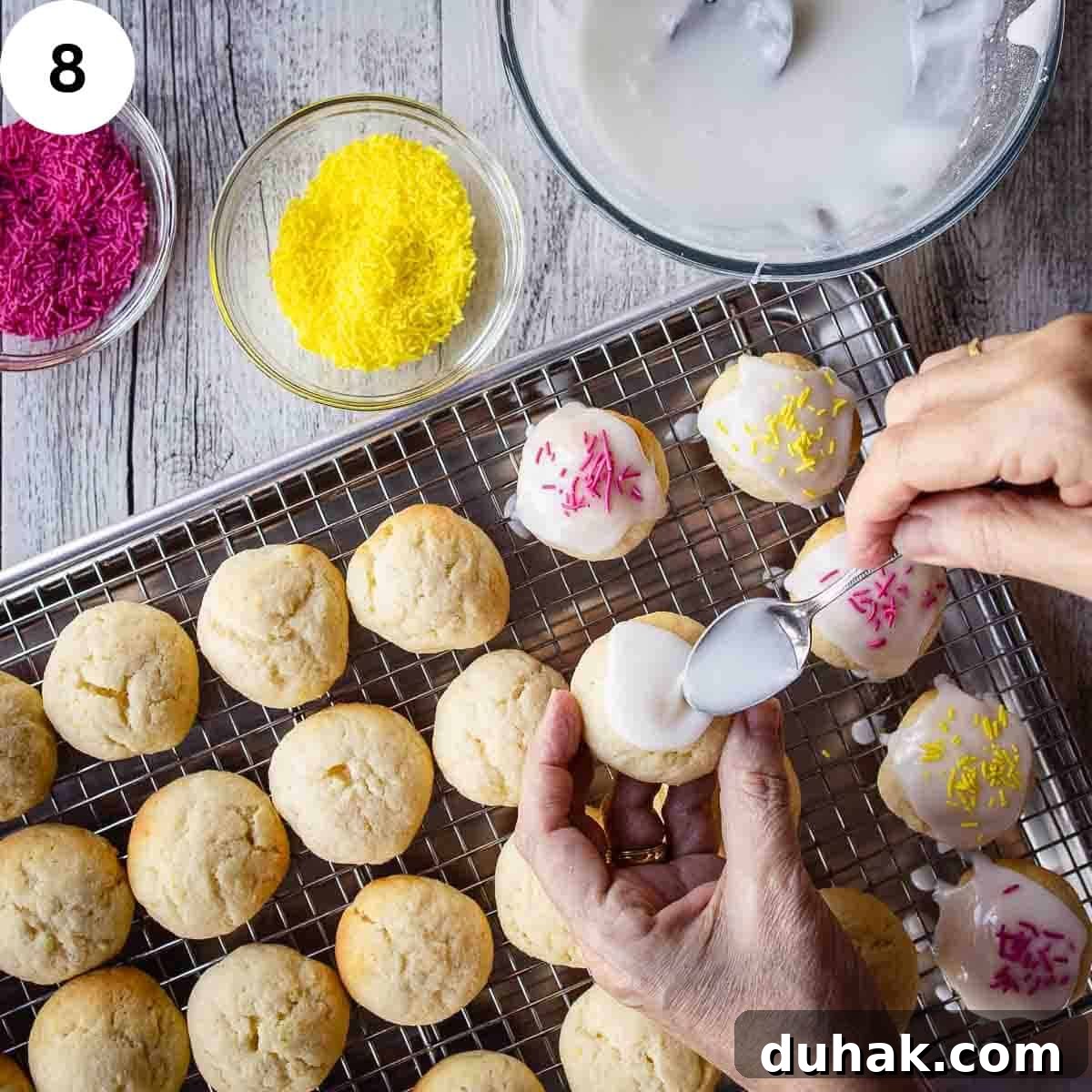 Lemon Ricotta Cookies Recipe — Soft, Zesty Citrus Cookies 11 Spreading glaze onto baked cookies.
