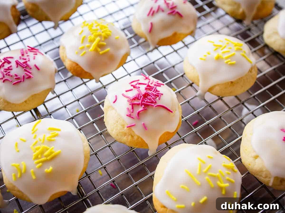 Lemon Ricotta Cookies Recipe — Soft, Zesty Citrus Cookies 12 Overhead close up of cookies with glaze and nonpareils.