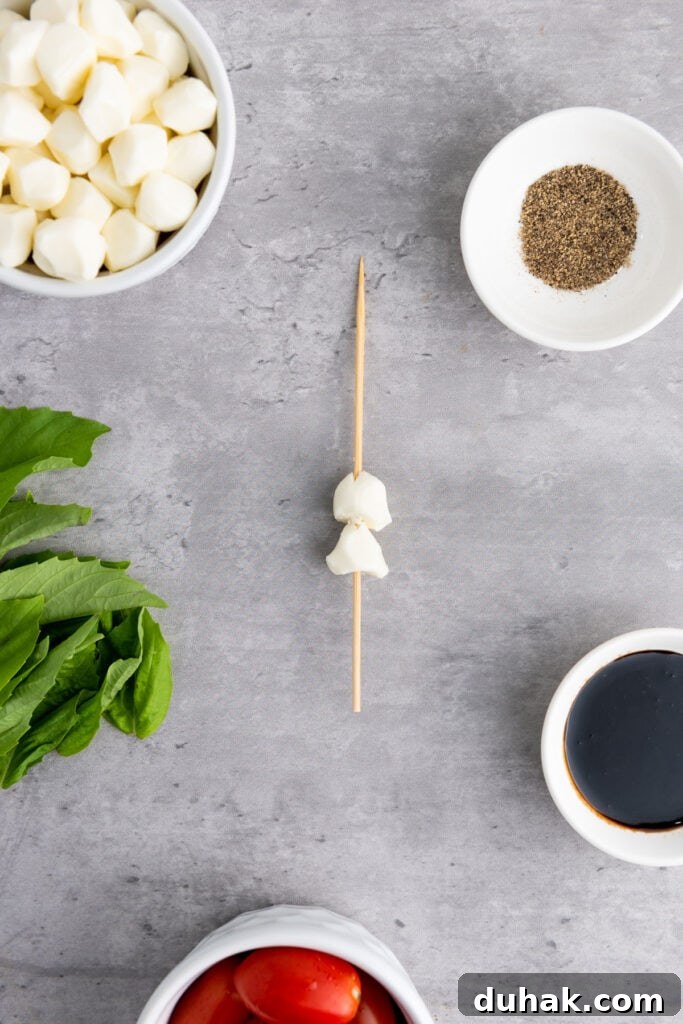 Caprese Skewers Recipe: Cherry Tomato, Mozzarella & Basil Bites 4 small mozzarella balls on skewer