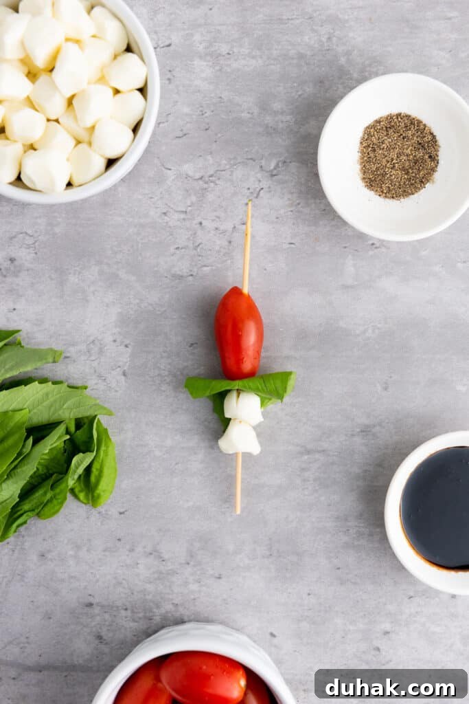 Caprese Skewers Recipe: Cherry Tomato, Mozzarella & Basil Bites 6 making caprese skewers