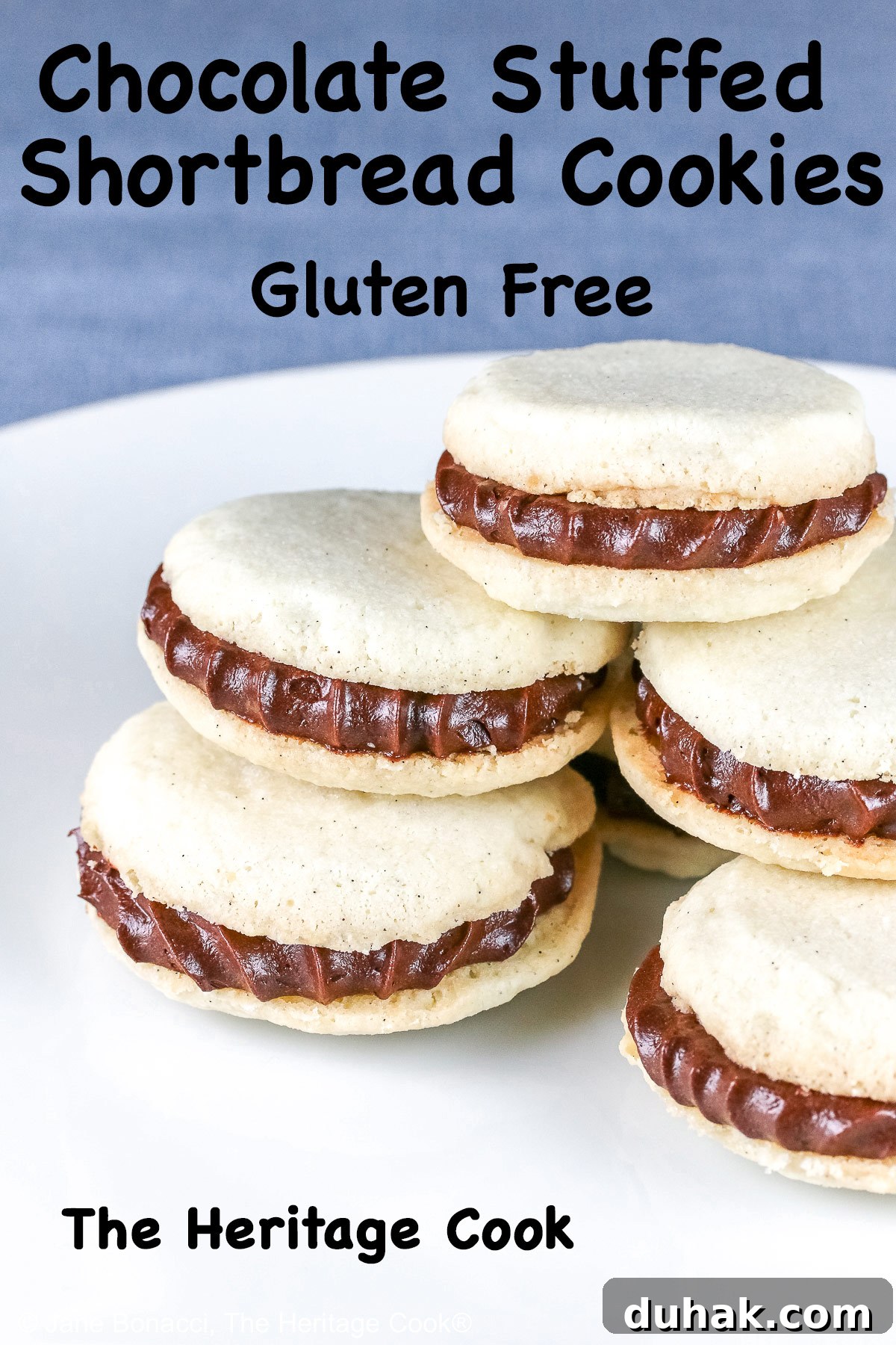 Stack of Chocolate Stuffed Vanilla Shortbread Cookies on either a white plate or blue plate on a bold blue background, the cookies staggered in a pile, the filling piped on with a star tip © 2025 Jane Bonacci, The Heritage Cook.