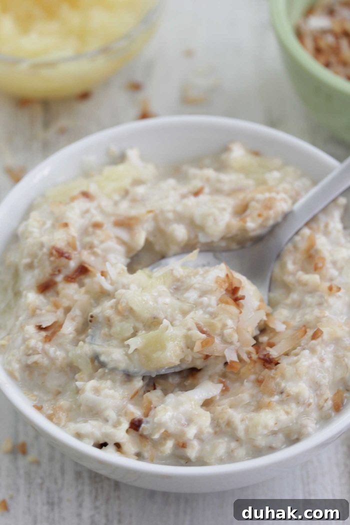 Pina Colada Overnight Oats Recipe for Tropical Breakfast 3 Piña colada overnight oats close up with a spoon