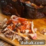 shredded smoked pulled pork butt in bbq sauce
