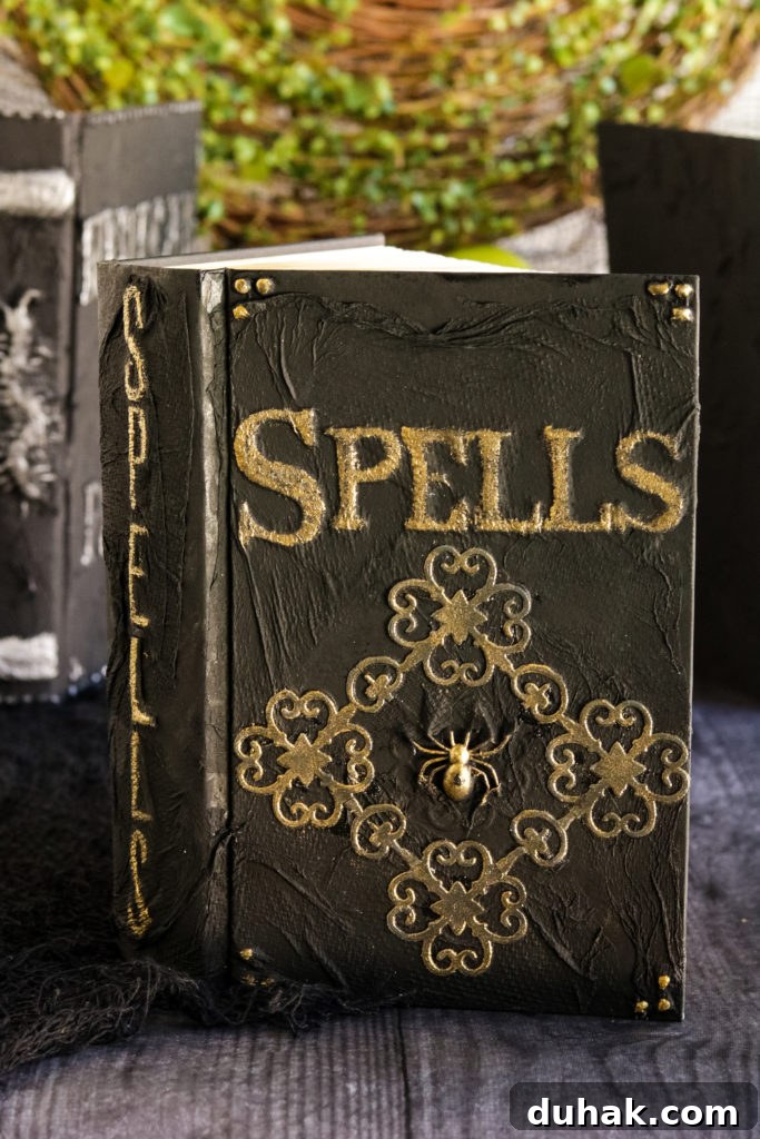 Create Your Own Spellbook: DIY Guide to Personal Grimoires 2 Black DIY Spell Book with gold painted embellishments and a golden spider in the center.