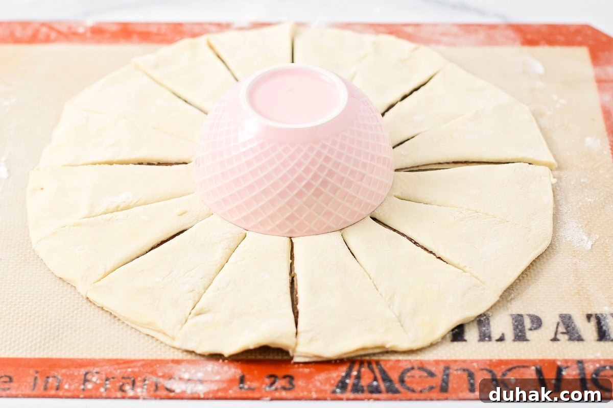 Cutting the strips from the center of the puff pastry round.