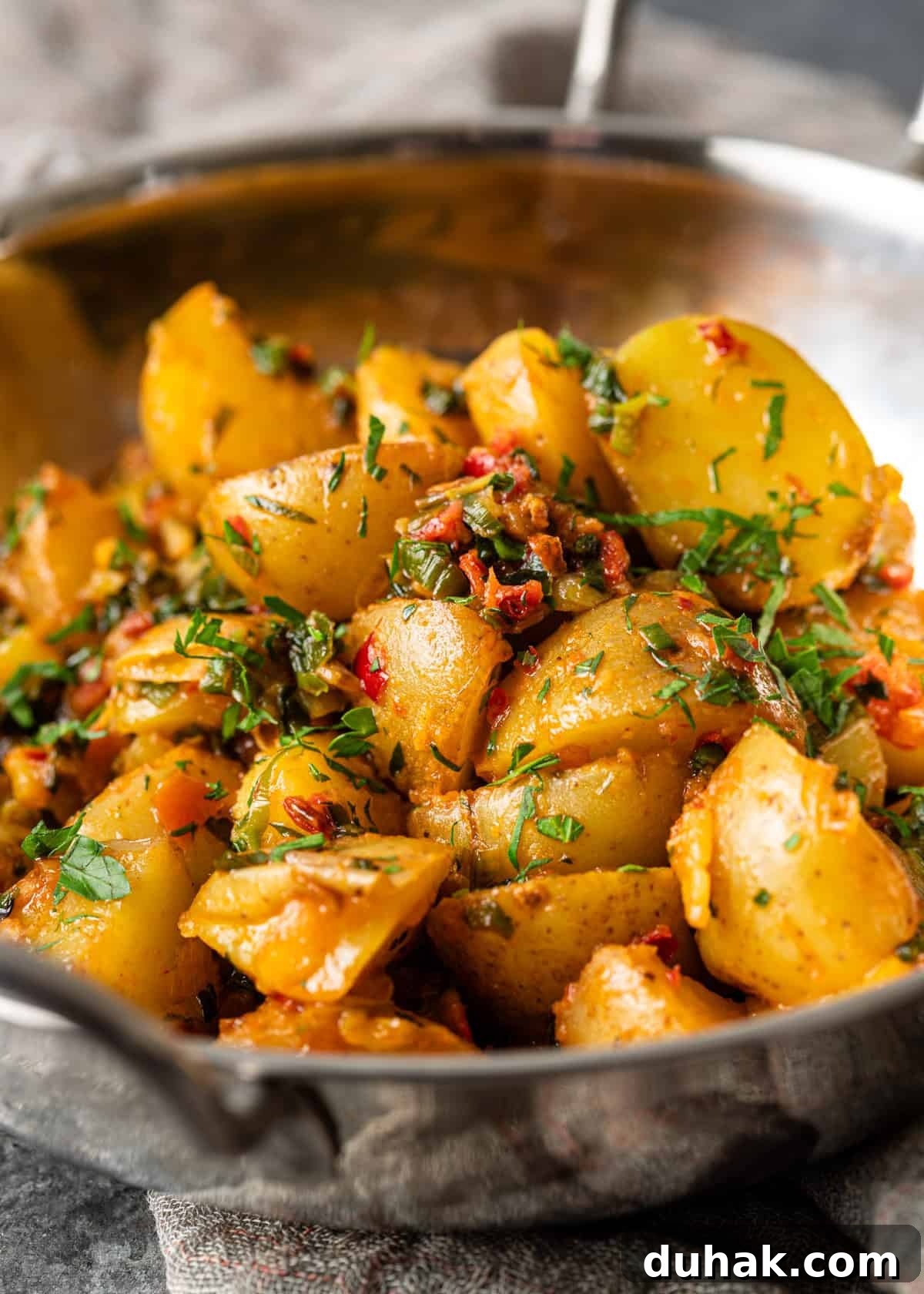 Spicy Calabrian Potatoes with Garlic and Chili Peppers 7 closeup: calabrian potatoes topped with chili and herb butter