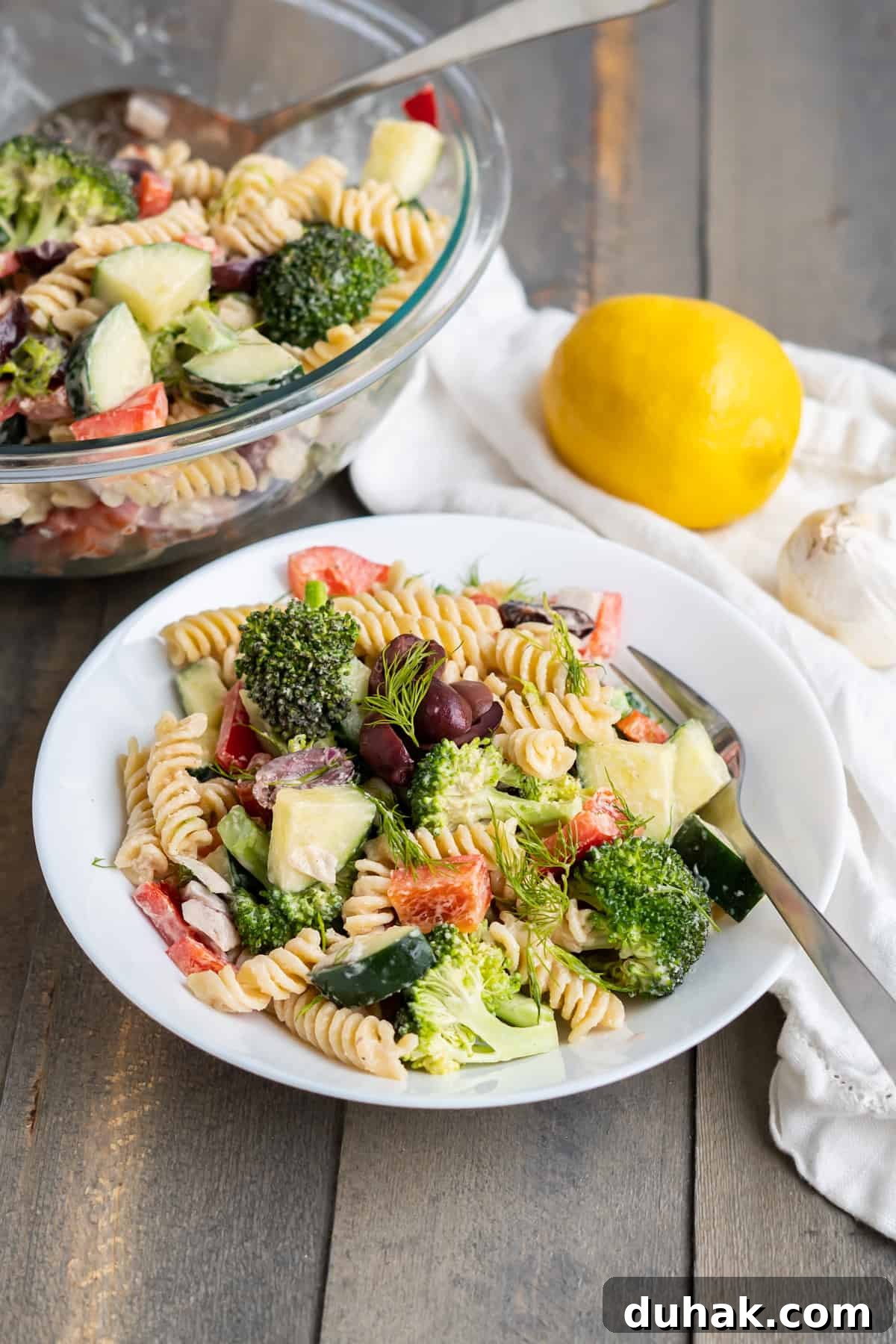 a bowl of greek pasta salad. 