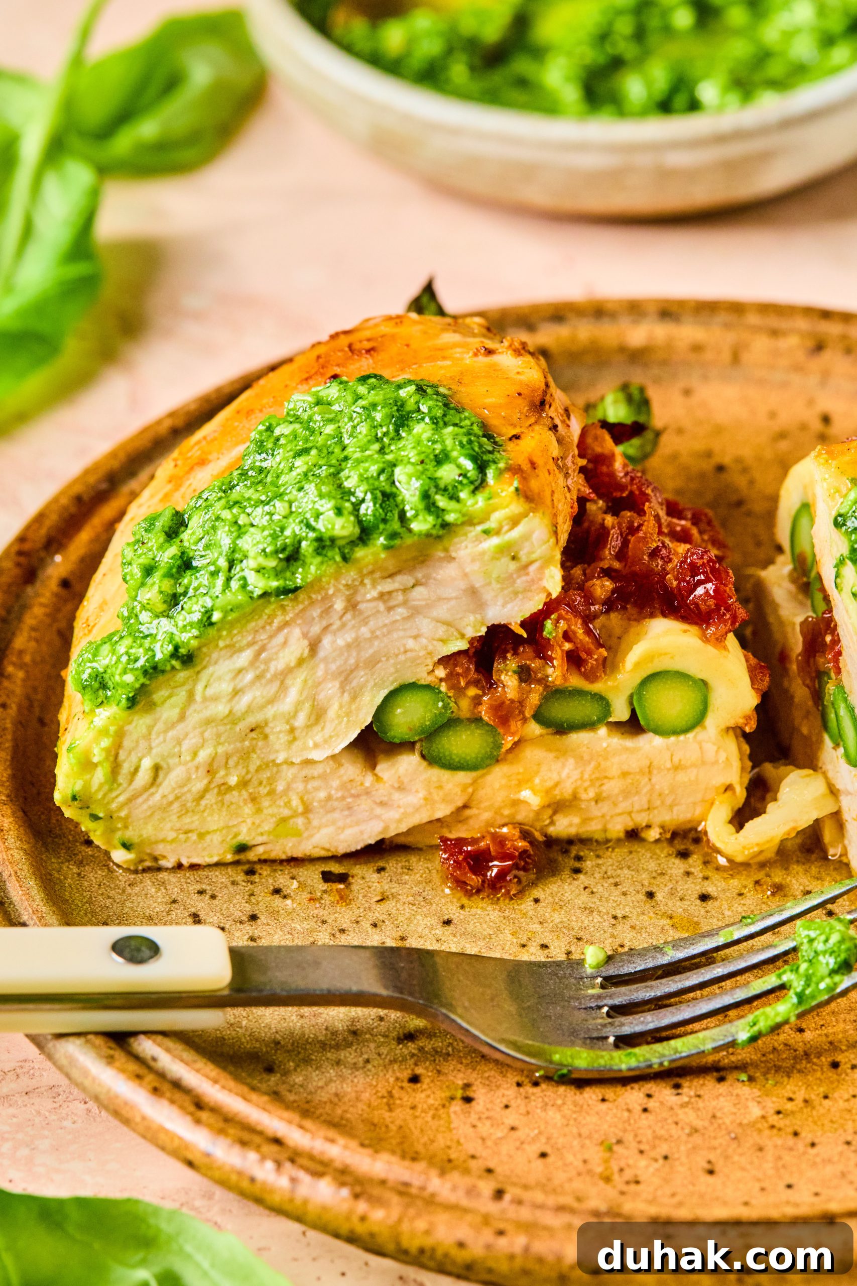 Asparagus and Sun-Dried Tomato Stuffed Chicken with Pesto and Cheese 13 A cheesy asparagus stuffed chicken breast cut in half to reveal the melty, cheesy inside
