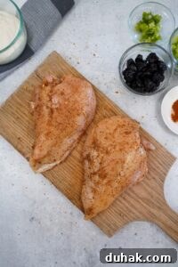 Season both sides of the chicken breasts with the BBQ rub and rub it in
