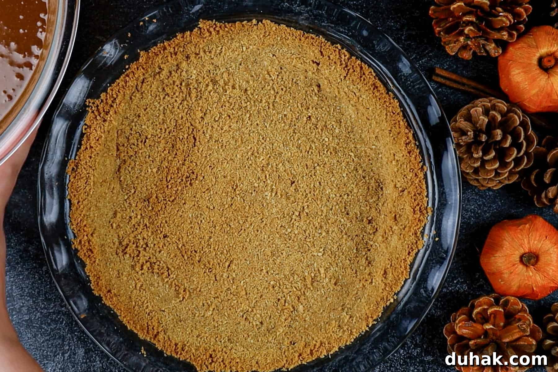 Decadent Chocolate Pumpkin Pie Recipe for Fall Desserts 8 Graham cracker crust baked in a glass pie dish.