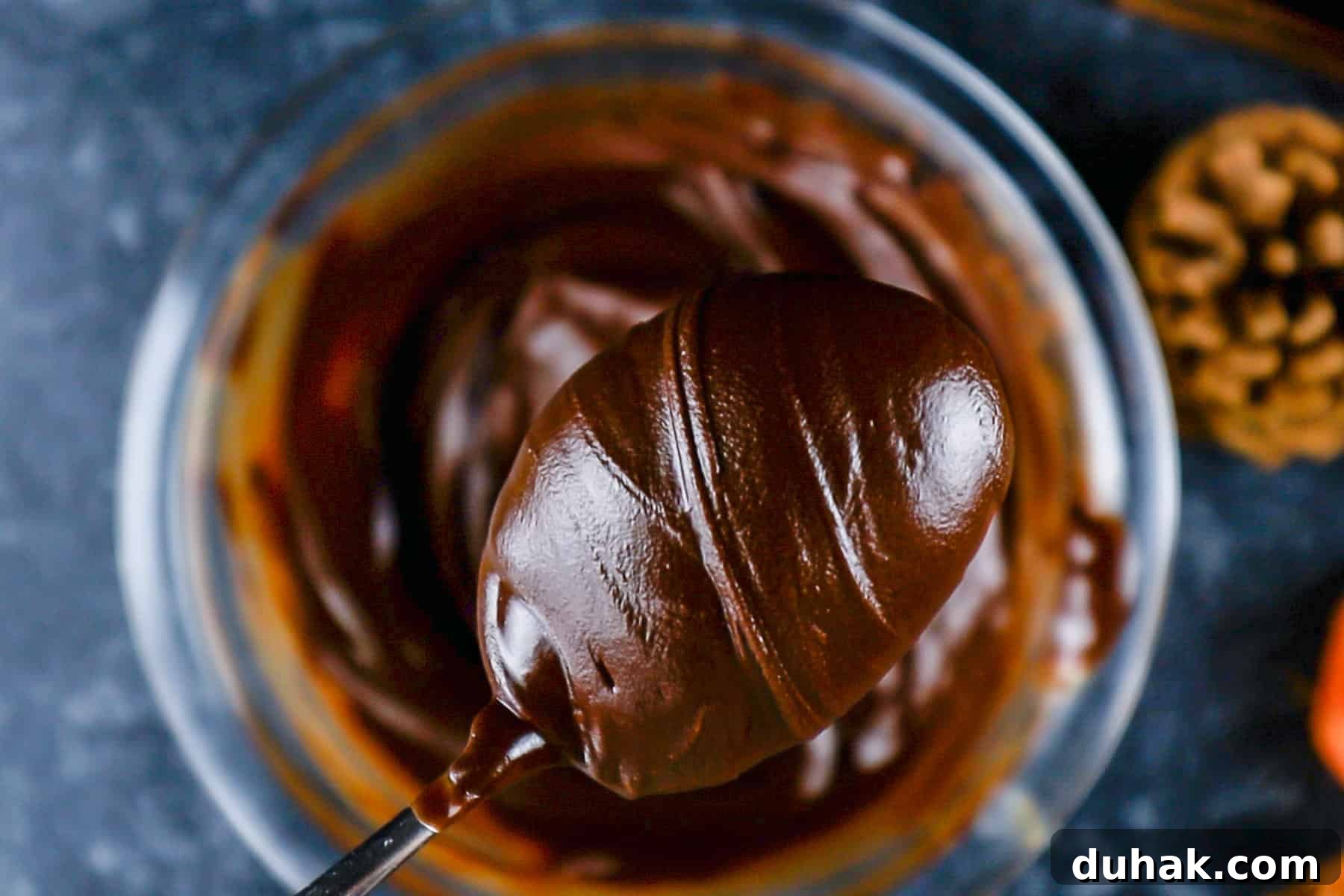Decadent Chocolate Pumpkin Pie Recipe for Fall Desserts 9 Melted chocolate chips and butter in a glass bowl and scooped out with a spoon.