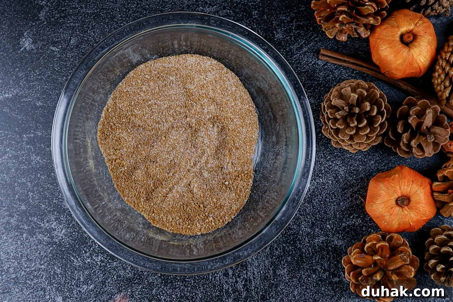 Decadent Chocolate Pumpkin Pie Recipe for Fall Desserts 10 Sugars and spices are mixed in a glass bowl.