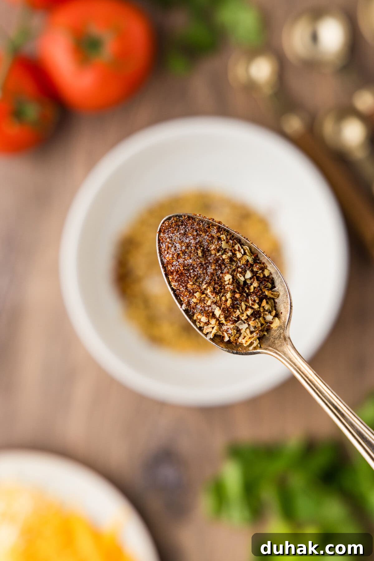 DIY Taco Seasoning Blend for Authentic Mexican Flavor 7 spoon full of homemade taco seasoning