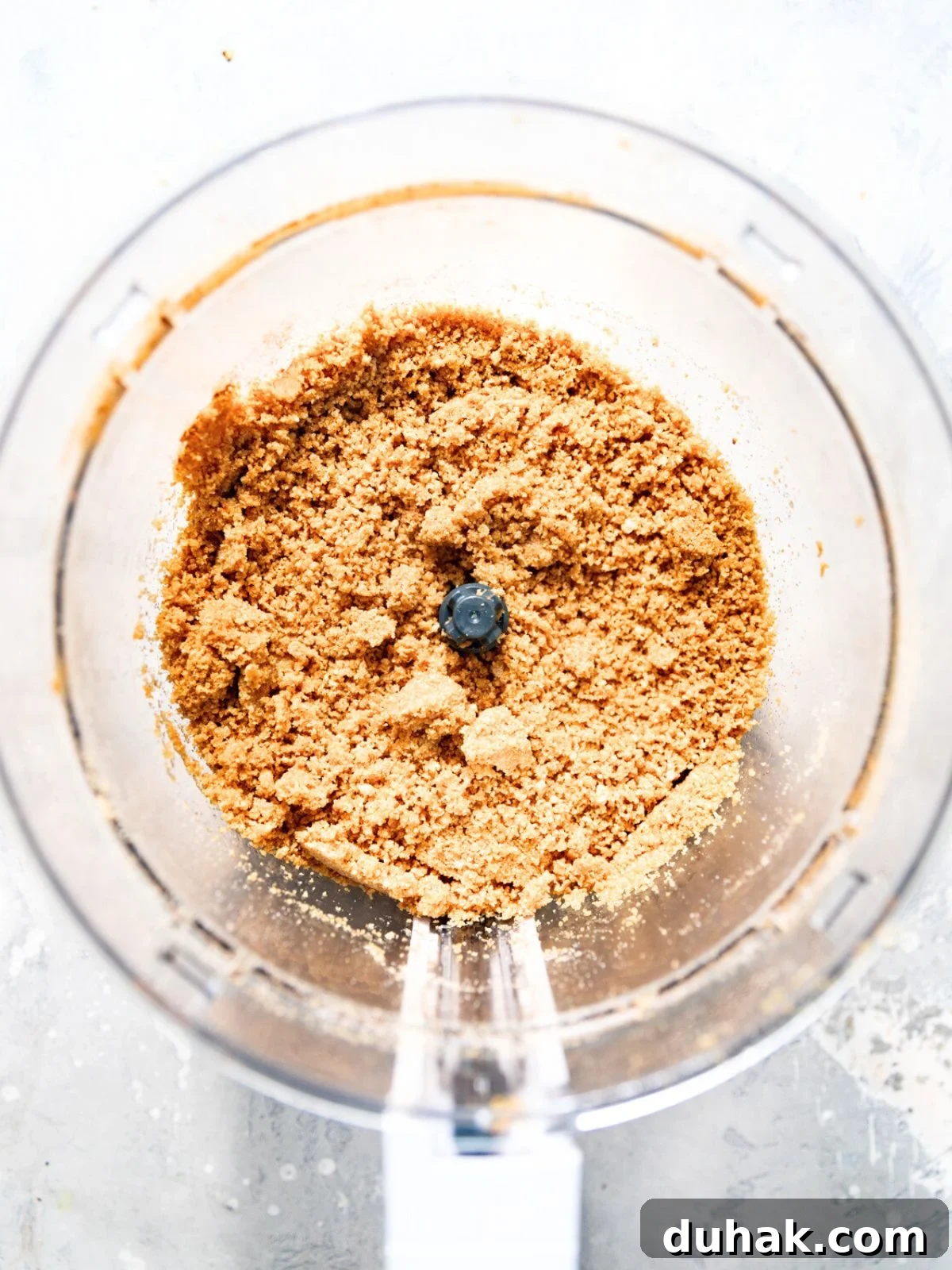 Silky Mascarpone Cheesecake Recipe with Luscious Cream Filling 4 biscoff cookies crushed in a food processor.