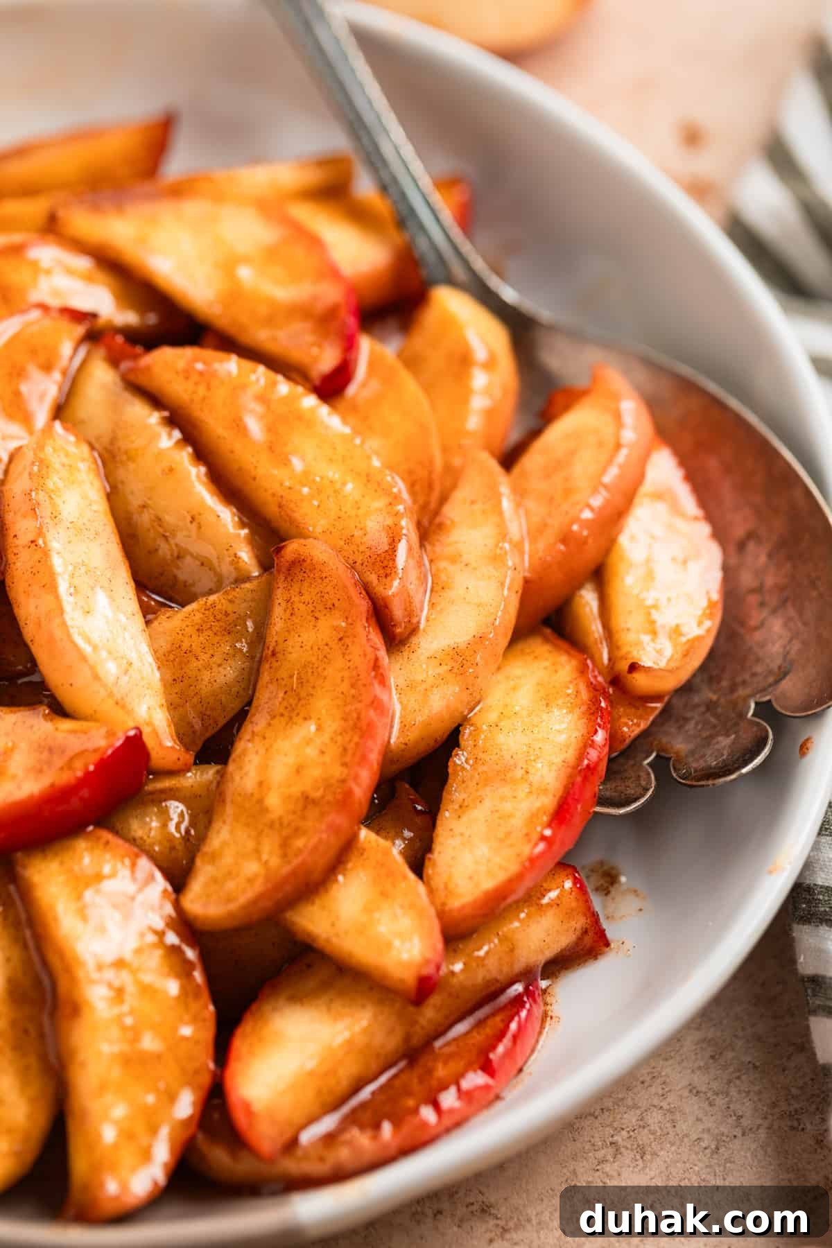 Air fried apples on serving dish with spoon.