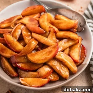 Plate with cinnamon sugar apples and serving utensil.