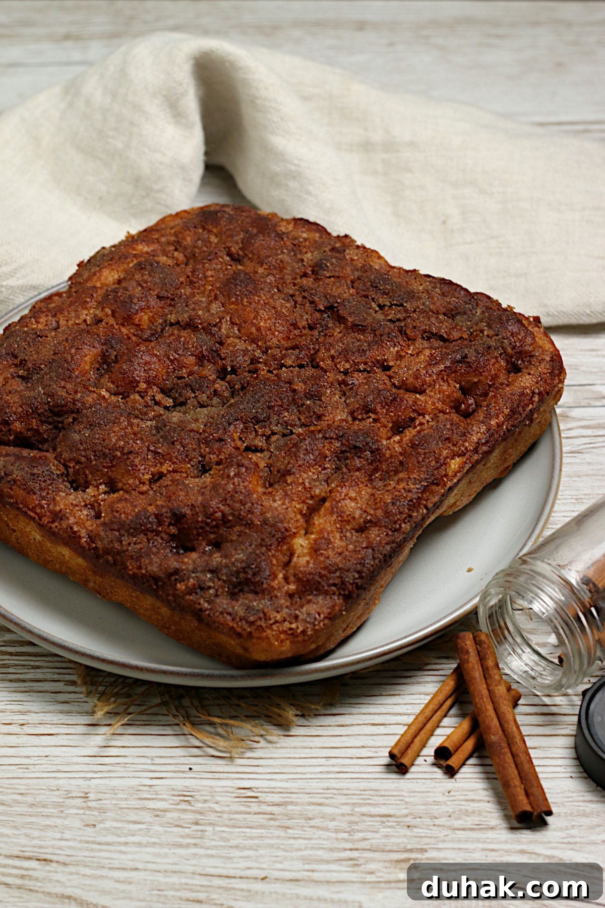 Cinnamon Toast Focaccia Recipe: Crispy Sweet Breakfast Bread 2 A whole loaf of Cinnamon Toast Focaccia on a large plate.