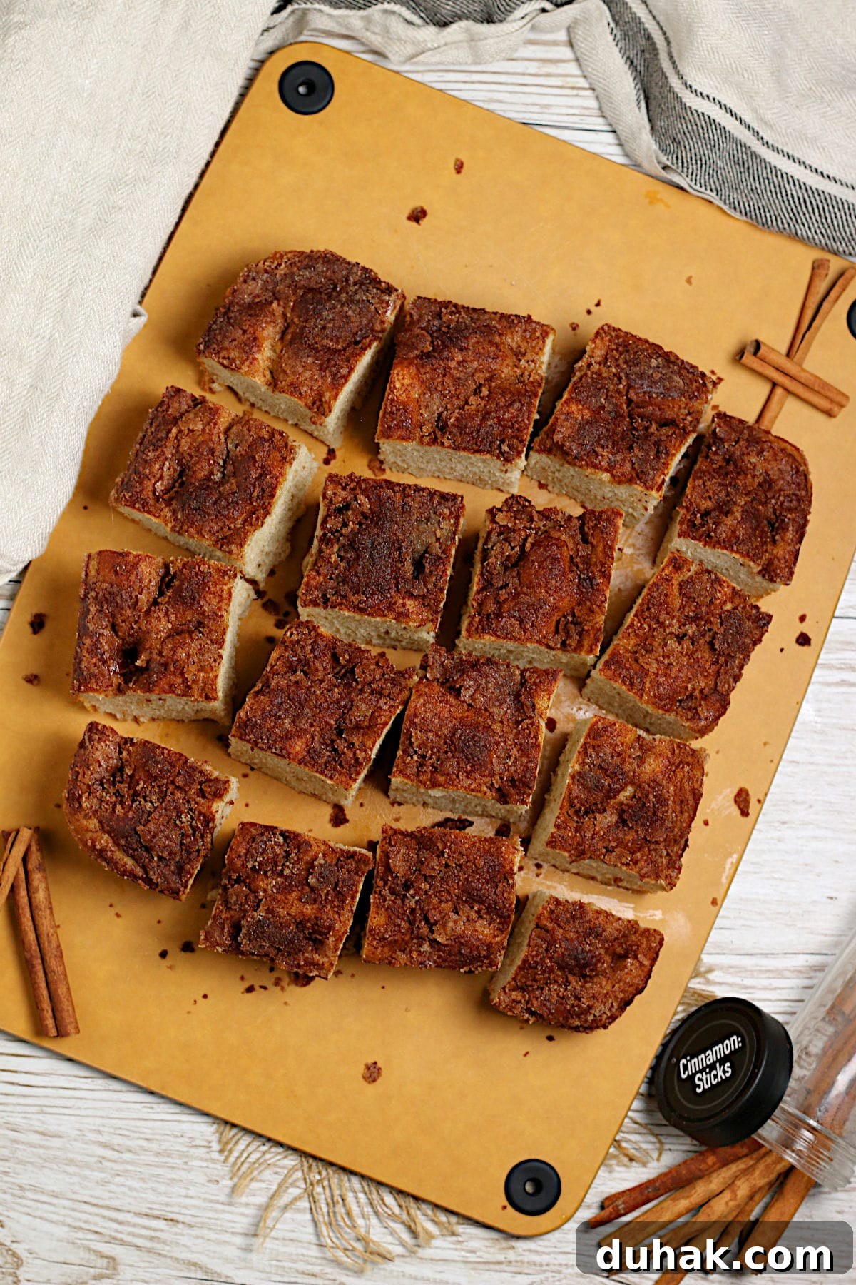 Cinnamon Toast Focaccia Recipe: Crispy Sweet Breakfast Bread 3 An overhead photo of a loaf of Cinnamon Toast Focaccia cut into squares.