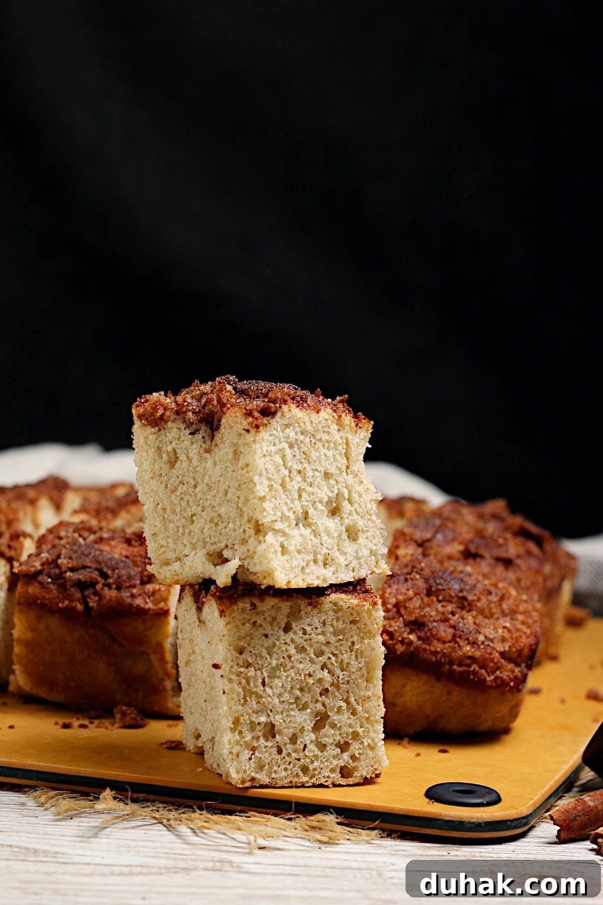 Cinnamon Toast Focaccia Recipe: Crispy Sweet Breakfast Bread 4 Two pieces of Cinnamon Toast Focaccia, one stacked on top of the other.