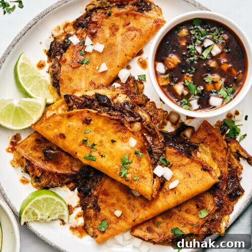 A plate of beef birria tacos.