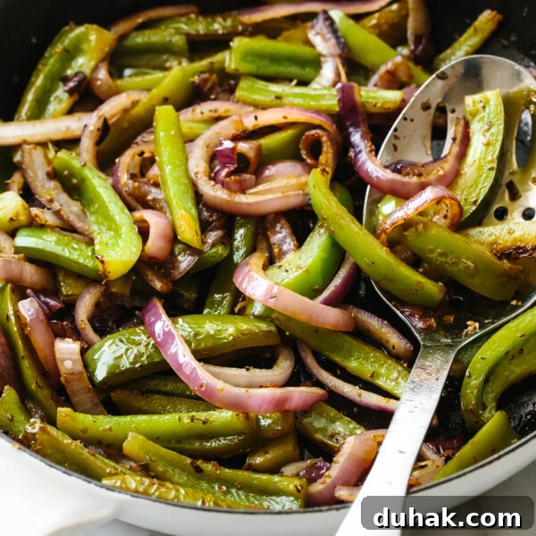 Sauteeing fajita veggies in a skillet.