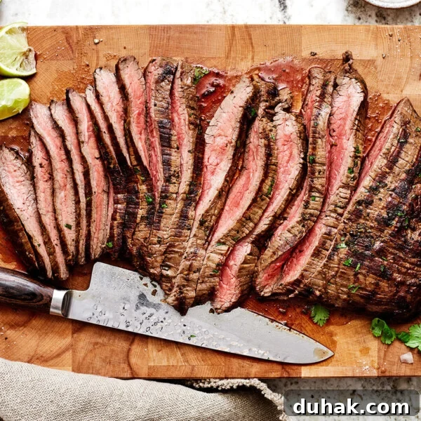 Sliced carne asada on a wooden board