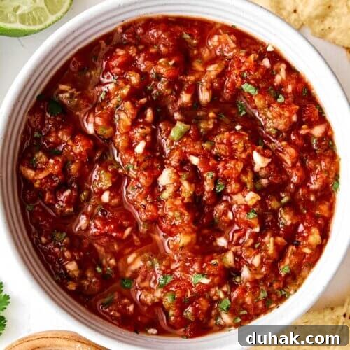 Red salsa in a bowl with chips.