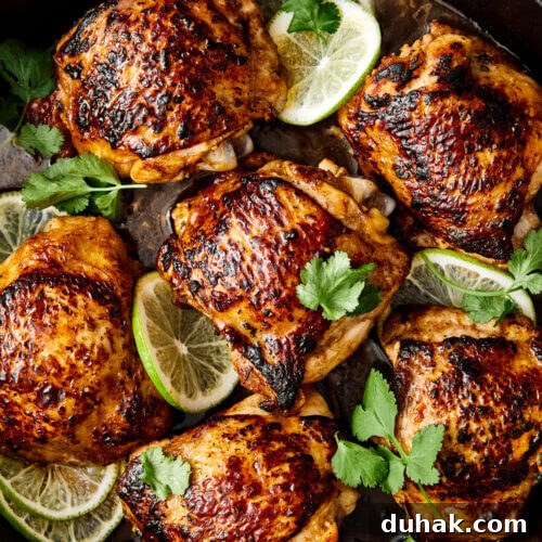 Cilantro lime chicken thighs with lime slices.