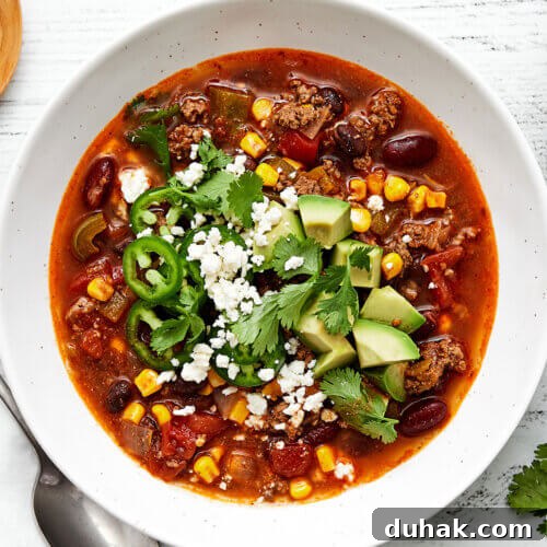 A bowl of taco soup with avocado