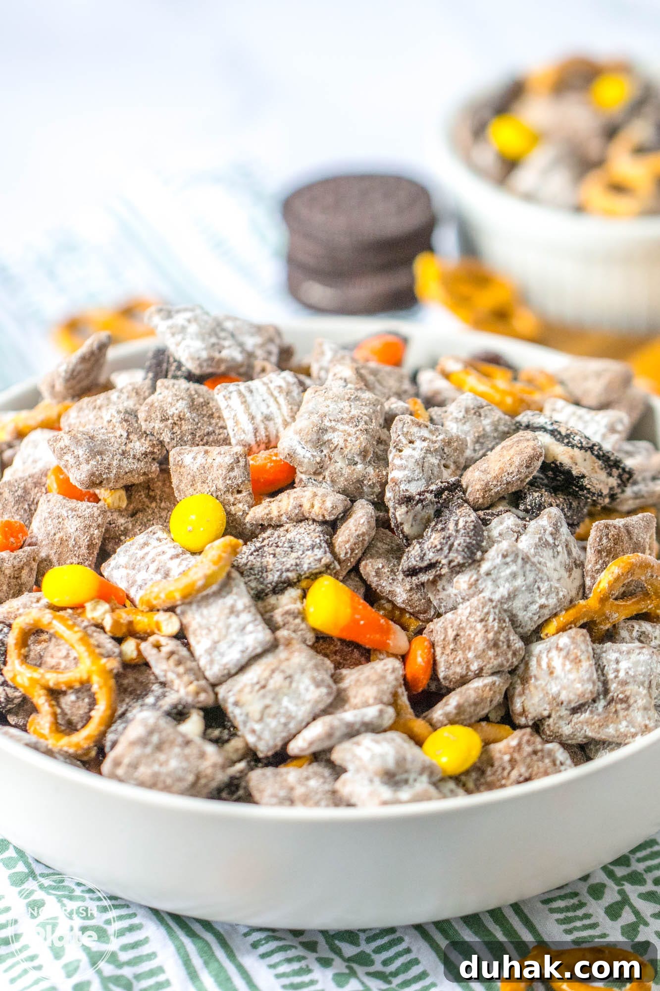 Autumn Puppy Chow Recipe: Seasonal Snack Mix for Fall 9 Angle shot of a large white bowl with fall puppy chow mix
