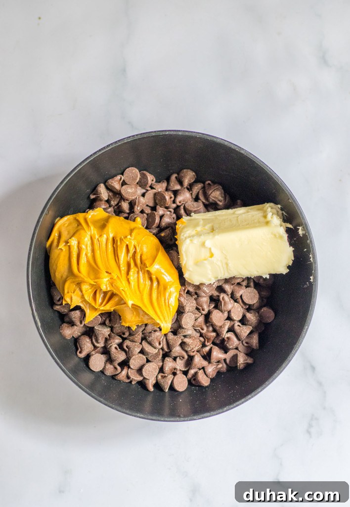 Autumn Puppy Chow Recipe: Seasonal Snack Mix for Fall 5 Chocolate chips, peanut butter, and butter in a black bowl