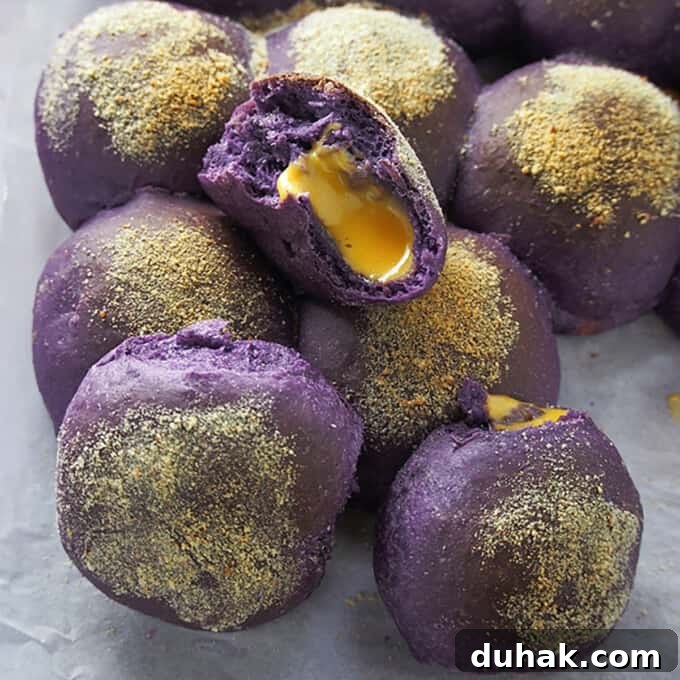 Ube Cheese Pandesal Recipe: Soft Filipino Purple Yam Rolls 7 ube pandesal with cheese filling on a parchment paper.