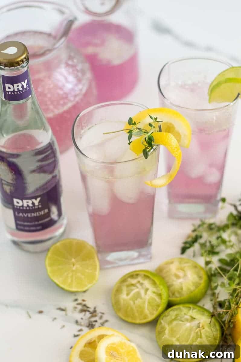 Glasses filled with lavender lemonade and lemon zest