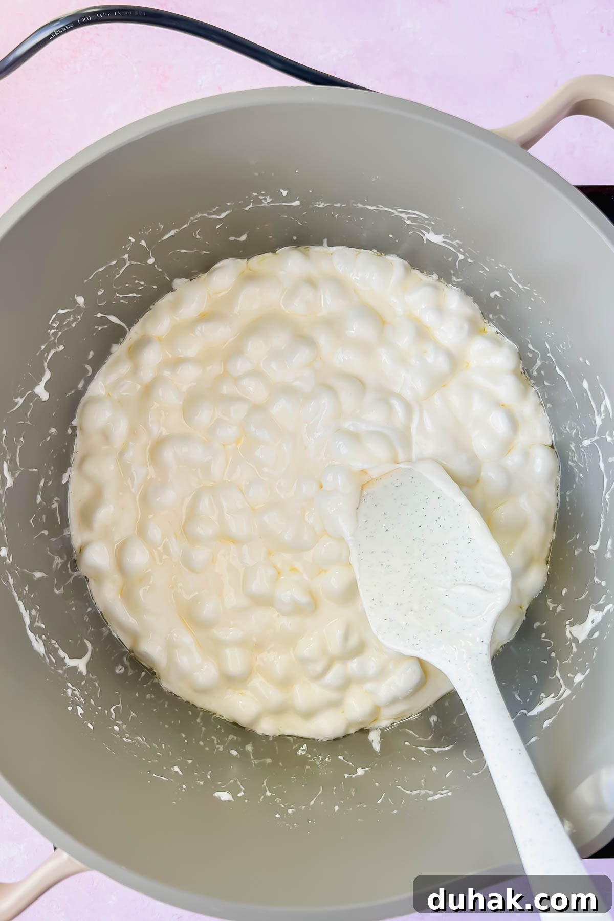 marshmallows melting in gray sauce pot.