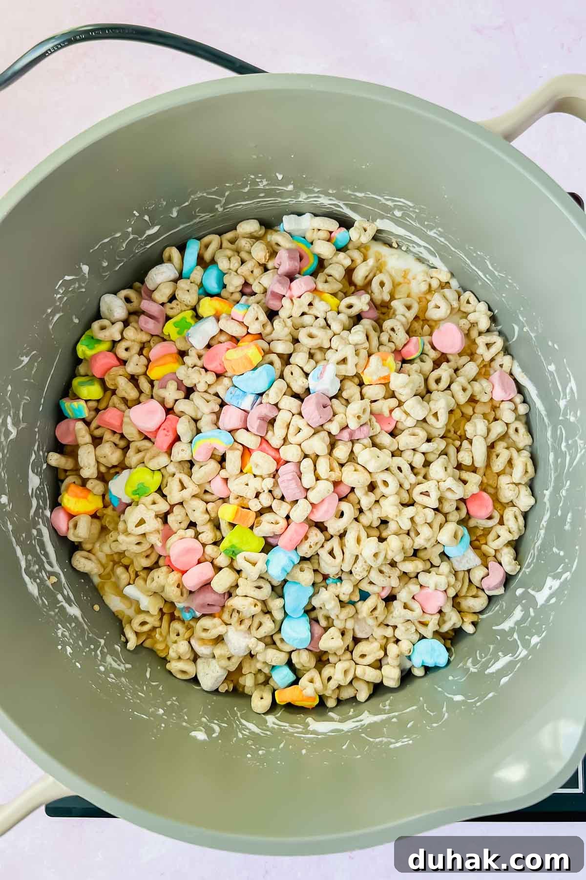 lucky charms in gray sauce pot with melted marshmallows.