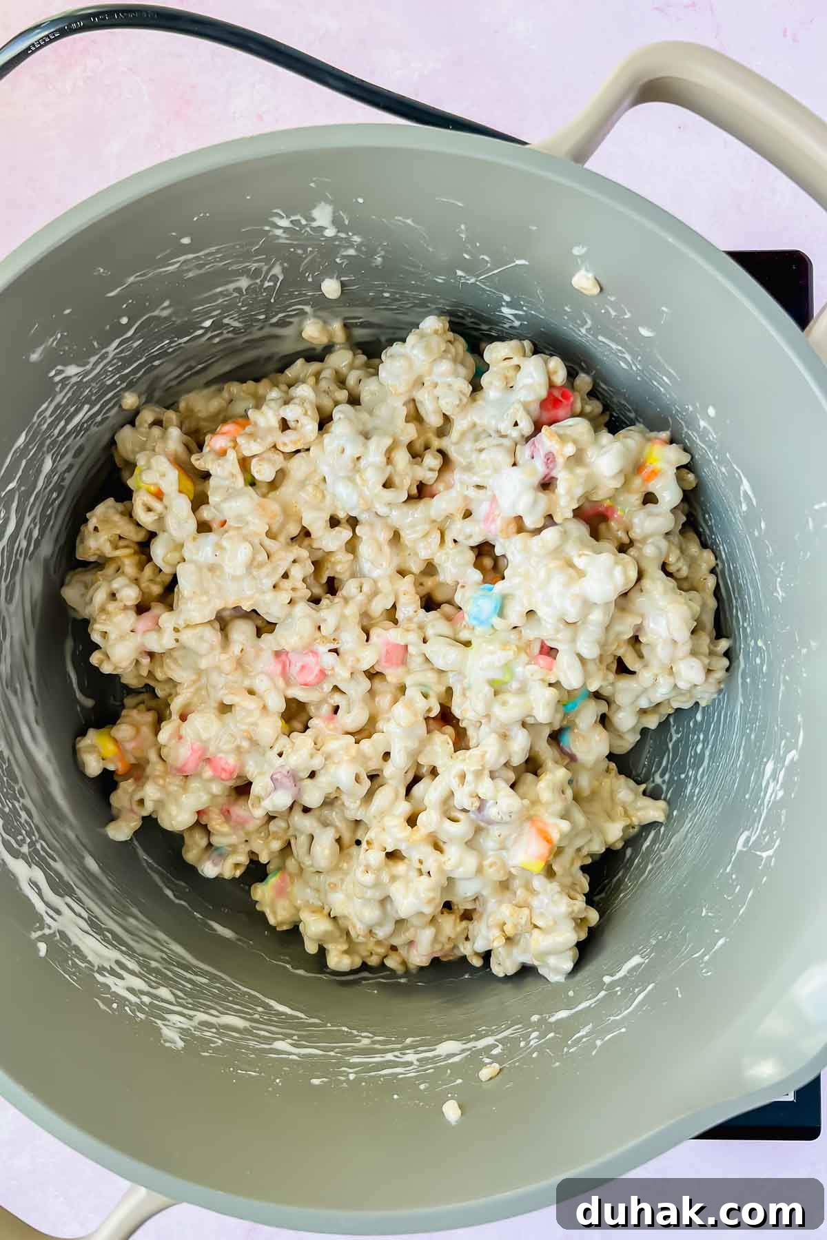 marshmallow covered cereal mixture in gray sauce pot.