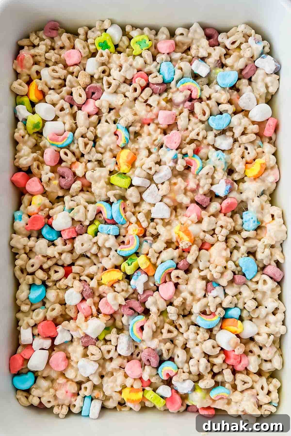 lucky charm rice krispie treats in rectangular baking dish.
