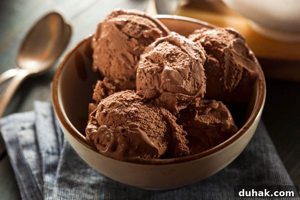 Stop Snacking: Dietitian-Backed Strategies to Curb Cravings 7 A dimly lit picture of a large bowl of chocolate ice cream.