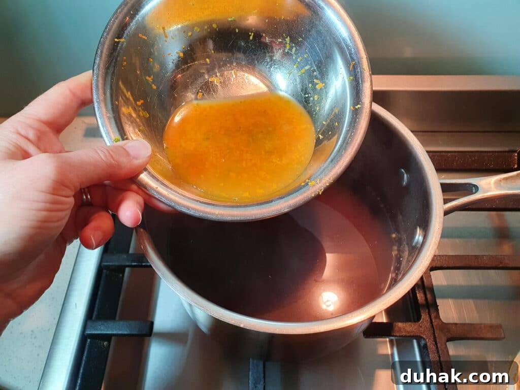 How to Make Homemade Cola Soda from Scratch 12 adding citrus juices and zest to saucepan.